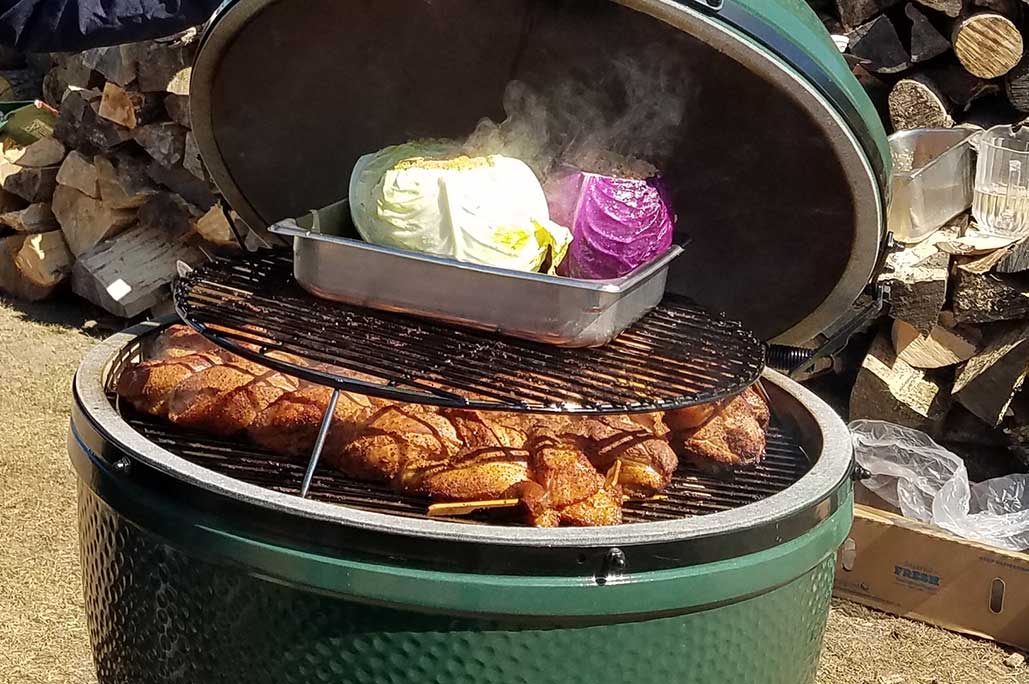 Big Green Egg with chicken and cabbage cooking
