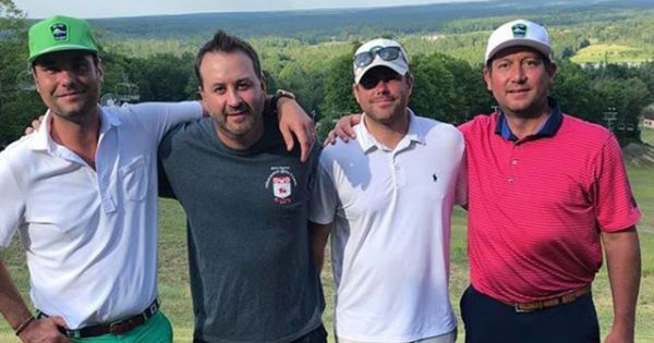 4 men on a golf course